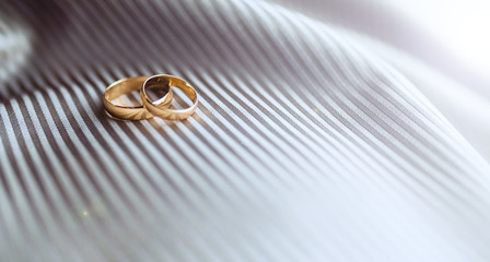 Wedding rings on fabric in stripes