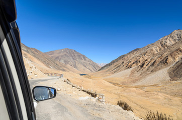 Beautiful Landscape of Sandstone mountain view from car window, Road trip in Leh Ladakh, North of India