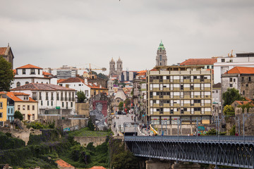 Fototapeta na wymiar Porto, Portugal - July 2017. View of the iconic Dom Luis I bridge crossing the Douro River, and the historical Ribeira and Se District in the city of Porto, Portugal. Unesco World Heritage Site.