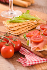 Crackers with ham and avocado. 