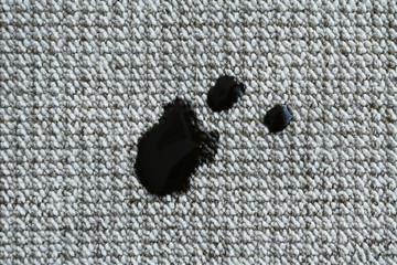 Black stains on carpet. Cleaning concept