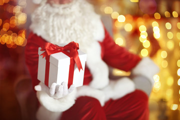 Fototapeta na wymiar Santa Claus with gift box on blurred background