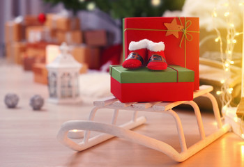 Christmas baby booties with gifts on sleigh