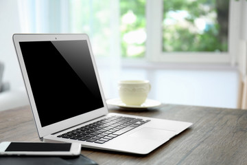 Comfortable workplace with modern laptop on table