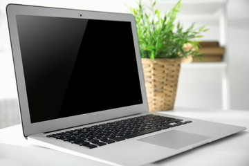 Comfortable workplace with modern laptop on table