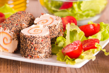 Goat cheese with salad and cherry tomatoes. 
