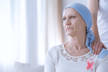 Sad woman with pink ribbon