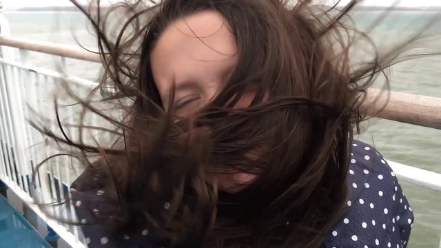 Young girl with hair being blow in slow motion