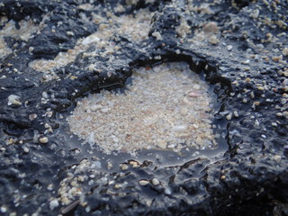 heart shaped stone with sand inside