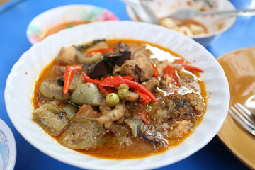 pea eggplant on Thai chicken green curry on white bowl