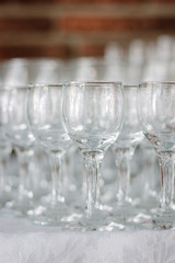 Row of glass on catering event on table.