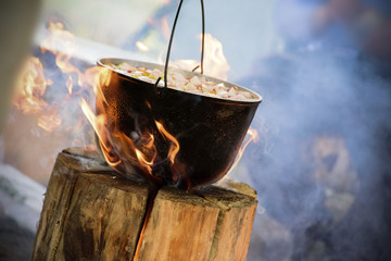 Cooking in cauldron on Finnish candle