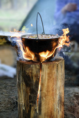Cooking in cauldron on Finnish candle