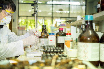 Scientists are titrating the concentration of chemicals. In the chemistry laboratory.
