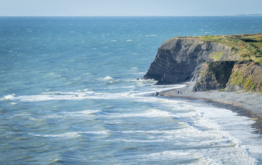 Blue Ocean Waves Crashing Against Scenic Shoreline