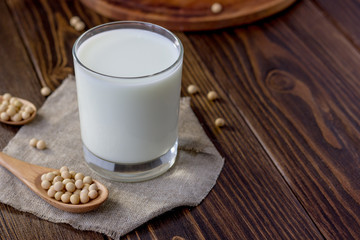 Soy milk with soy beans around it.