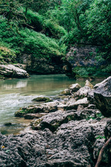 River in Guamskoe Gorge, Russia, North Caucasus, beautiful nature landscape with river among rock mountains and forest