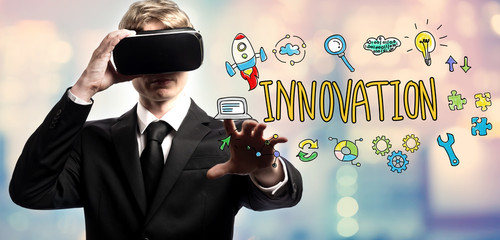 Innovation text with businessman using a virtual reality headset