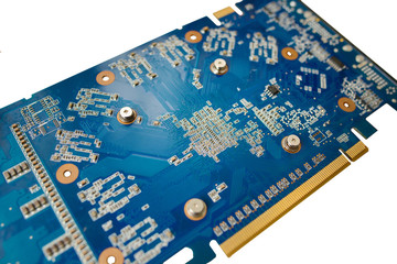 Blue isolated motherboard or computer boar with chips and component on it on a white background