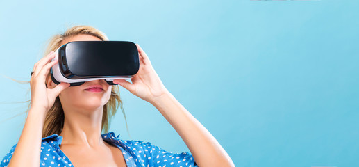  Happy young woman using a virtual reality headset
