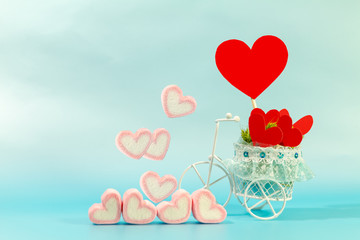 Vintage bicycle model transport a red heart and marshmallows for supporting when people get who lack of desire with love and Valentine's Day concept.