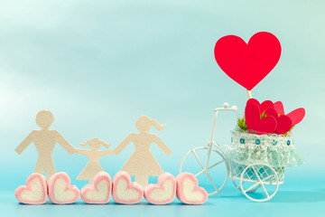 A family with model and marshmallows and vintage bicycle model transport a pink heart for supporting when people get who lack of desire with love and Valentine's Day concept.