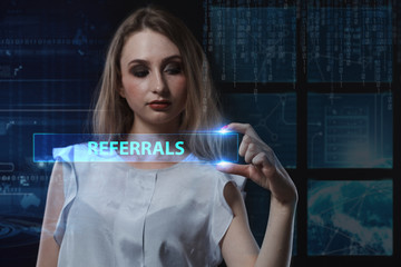 The concept of business, technology, the Internet and the network. A young entrepreneur working on a virtual screen of the future and sees the inscription: Referrals