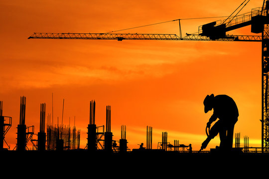 Silhouette images of construction sites are underway and workers are working