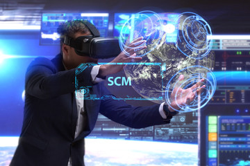 Business, Technology, Internet and network concept. Young businessman working in virtual reality glasses sees the inscription: SCM