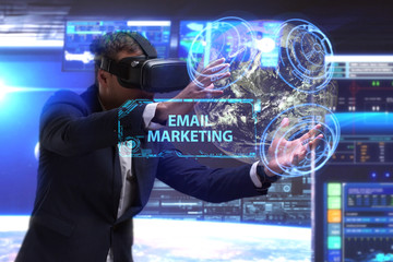 Business, Technology, Internet and network concept. Young businessman working in virtual reality glasses sees the inscription: Email marketing