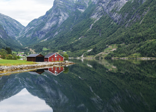 red wooden house at norway fjord