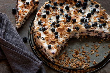 Sour cream cake with granola, biscuits and blueberries