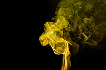 Movement of yellow smoke abstract on black