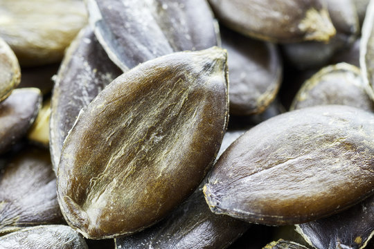 Extreme close up picture of pumpkin seeds, shallow depth of field.