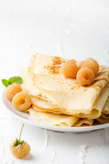 Homemade  crepes served with fresh yelllow raspberries