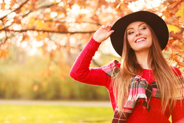 Charming woman walking in autumnal park