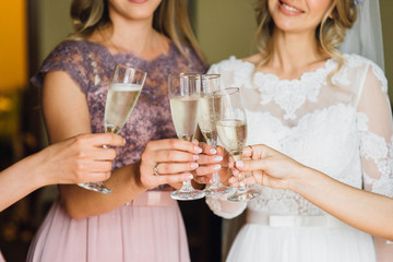 The bride and girlfriend drink champagne. Close-up

