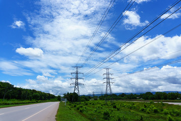 500 KV transmission line in maemoh lampang thailand. electricity transmission pylon with blue sky and cloud.