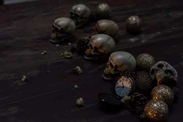 Awesome pile of skull and bone on a brown cloth background, Still life style, selective focus, halloween concept.
