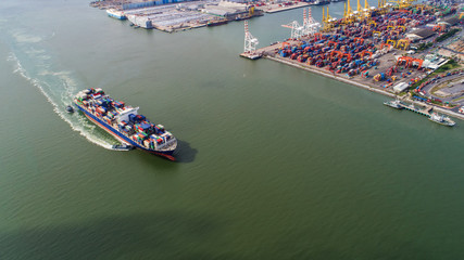 Fototapeta premium container,container ship in import export and business logistic,By crane,Trade Port , Shipping,cargo to harbor.Aerial view,Water transport,International,Shell Marine,transportation,logistic,trade,port