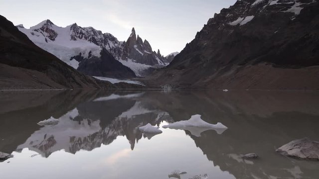 famous mount cerro torre and its neighbors mt. torre egger and punta herron and Iceberg formations at sunset reflecting in the Glacier Lake inside the los glaciares national park, Patagonia, Argentina