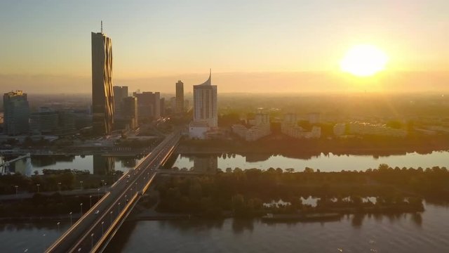 vienna skyline aerial view flying to skyscrapers on danube river at sunrise