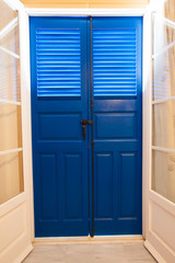 Blue door and window  with shutters
