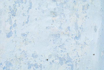 Old white with blue wall with cracks for background or texture horizontal.
