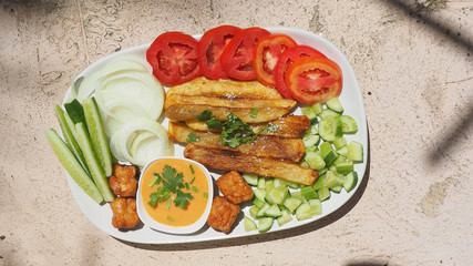 French fries with Thousand Island salad sauce served and vegetable