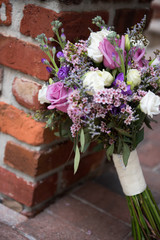 Beautiful wedding bouquet leaning against brick
