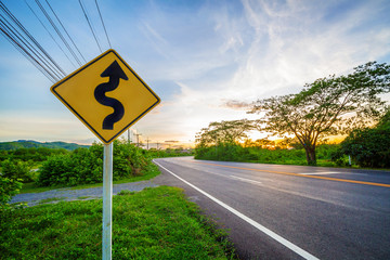 Winding road sign in the morning sky, Go for brighter future concept