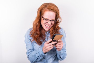 attractive young woman likes what she sees on the smartphone