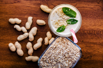 Dry oatmeal porridge, peanuts and cocktail of mint, banana and sesame