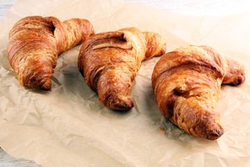 freshly baked croissants on white board, bakery concept